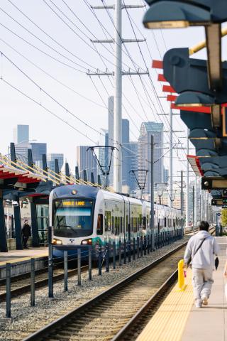 photo of Link 1 Line at SODO station with Seattle Skyline in the background
