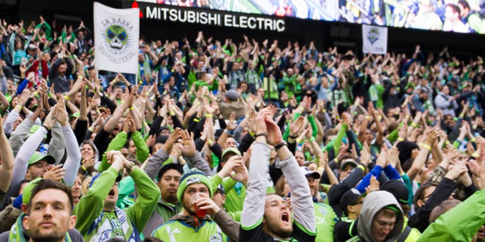 Fans cheer at a Sounders FC match.