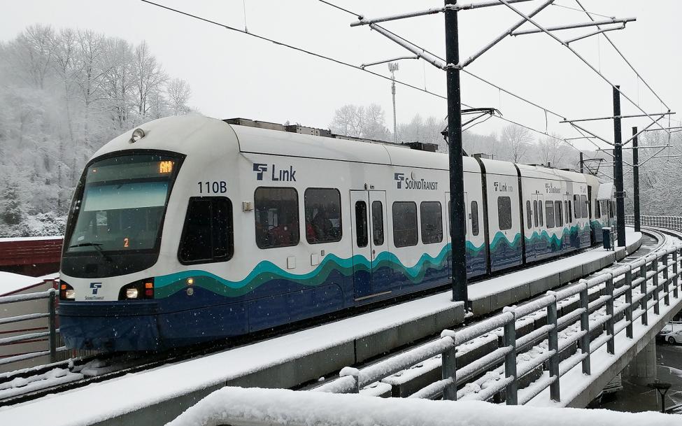 A link train approaching Mount Baker Station in the snow
