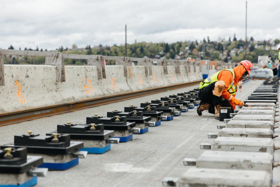 A worker installing the special blocks on I-90 which the light rail tracks will rest on.