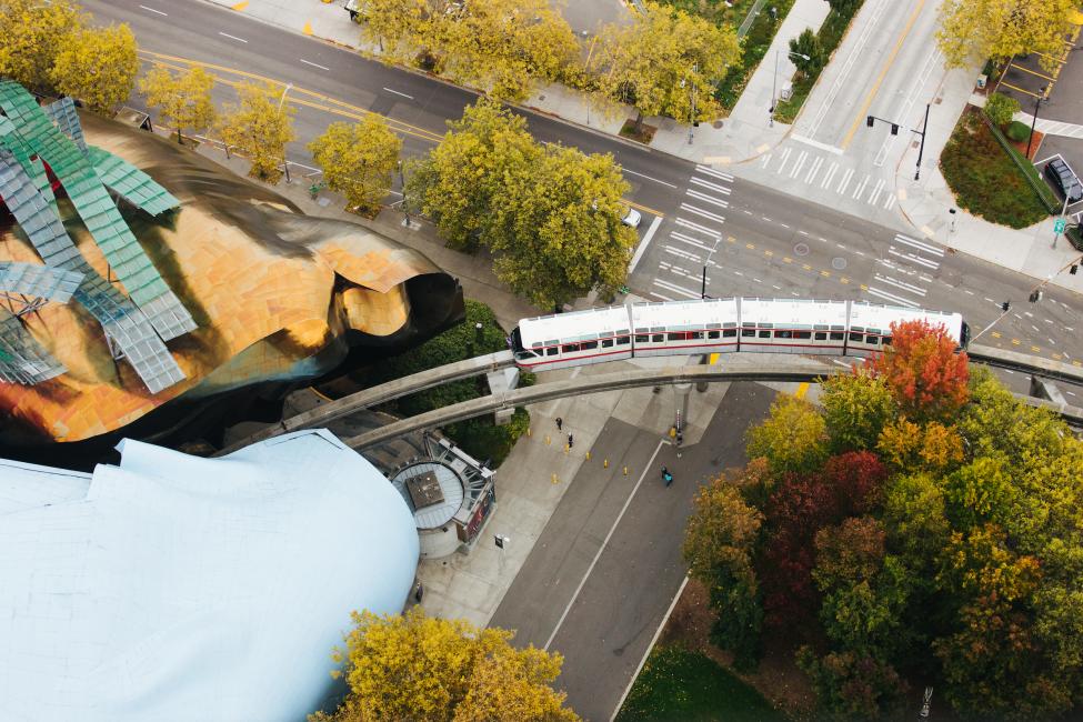 An aerial view of the monorail passing by the Museum of Pop Culture (MoPOP).