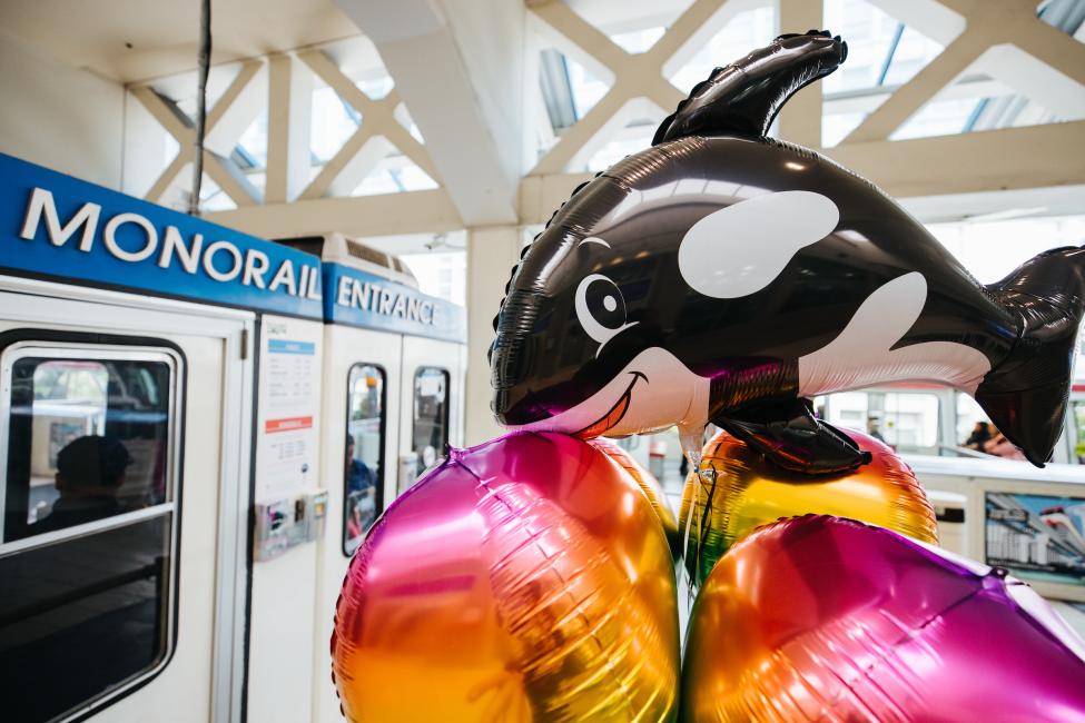 An Orca-shaped balloon is outside the entrance to the Seattle Center Monorail.