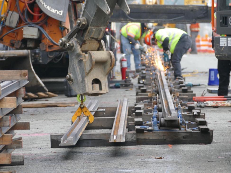 Crews weld sections of rail together in Tacoma.