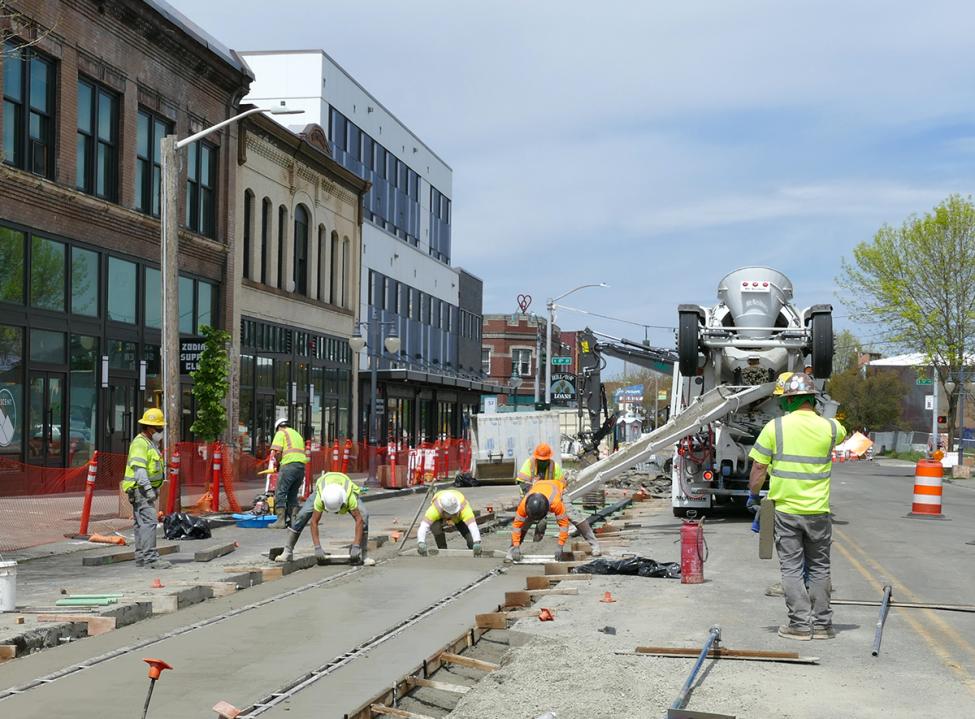 Crews work on light rail installation in Hilltop. The "253 heart" on top of a building can be seen in the background.