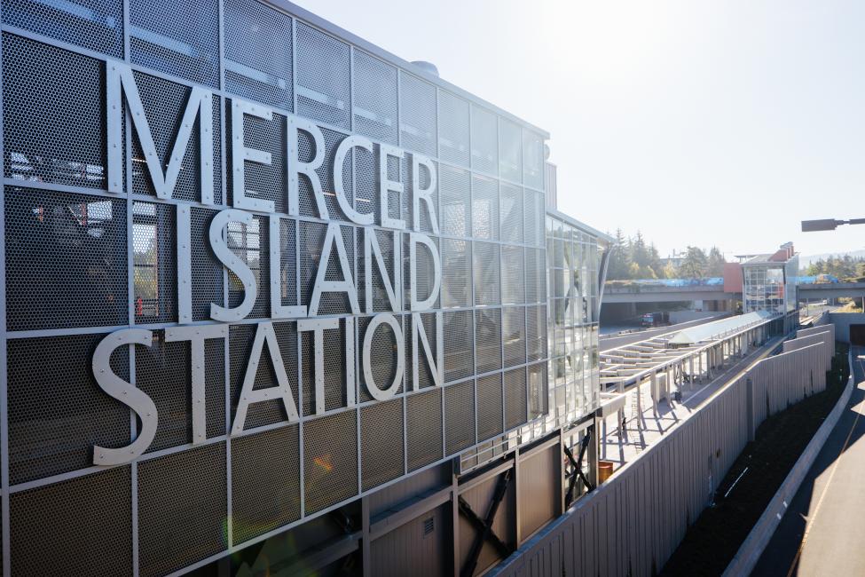 Large block letters on the side of a transit center read 'Mercer Island Station.'