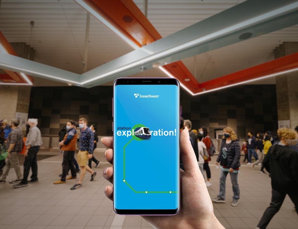A picture of a phone with an image on it that says "Station Exploration" with a train coming out of it.