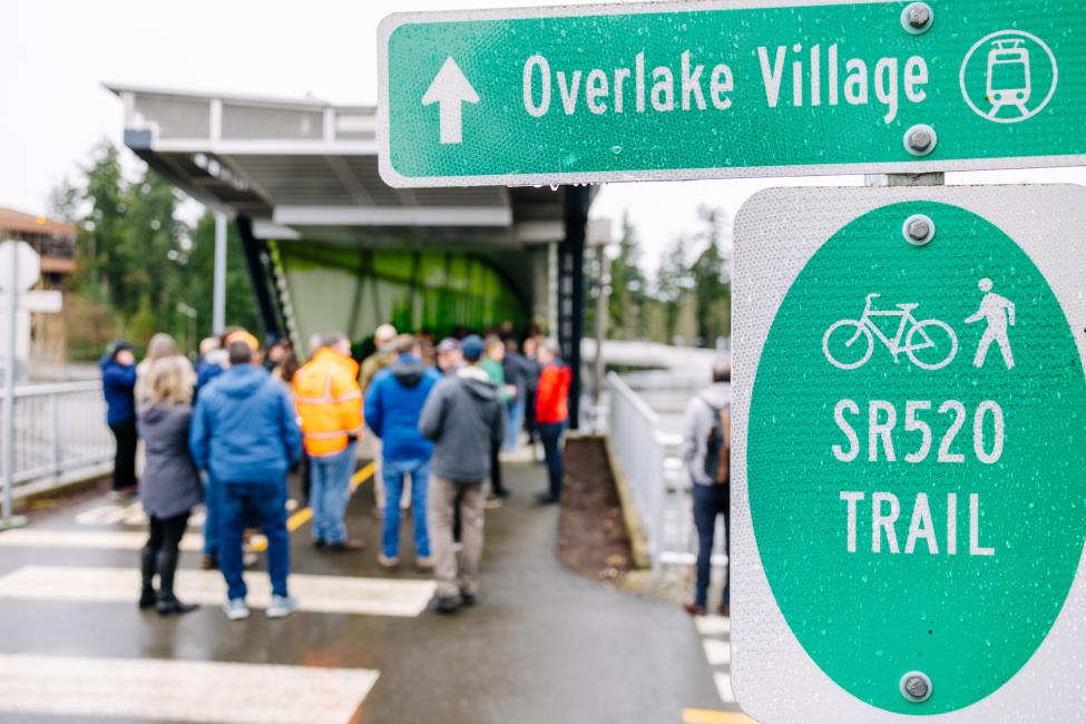 A sign shows directions to Overlake Village and the SR 520 trail