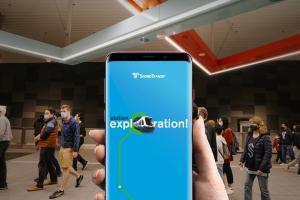 A phone screen shows an image that reads 'Welcome' and 'Station exploration.'