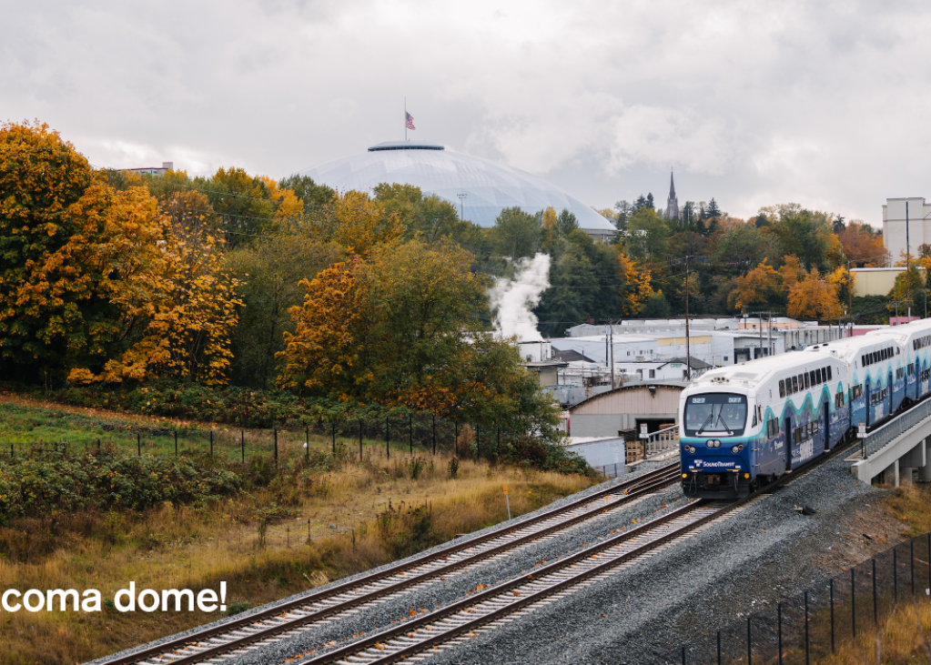 A Sounder train on the tracks in front of the Tacoma Dome