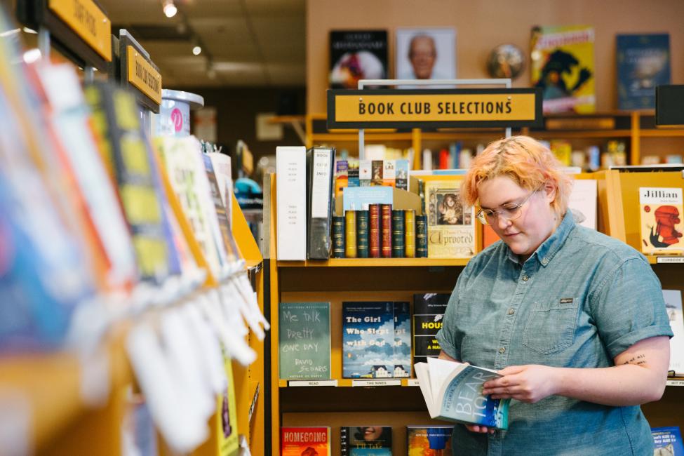 An employee shelves a book at Third Place Books in Lake Forest Park