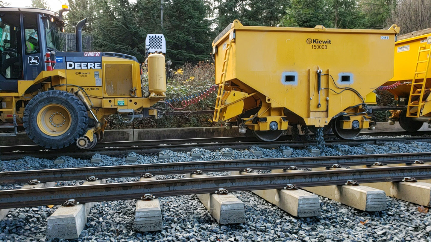 Crews use a high-rail vehicle and ballast cars to ‘flood’ the rail with ballast.