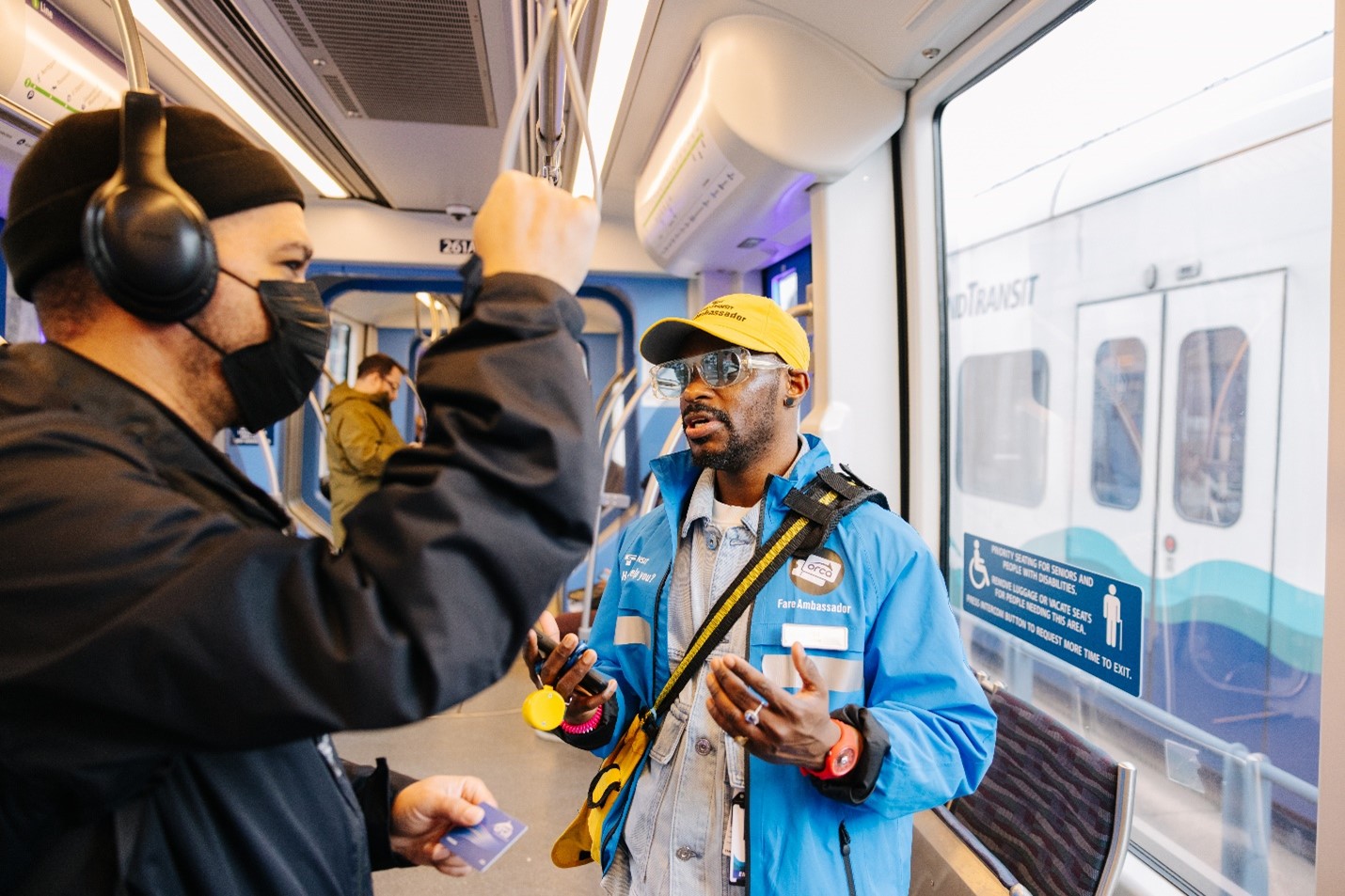 Fare ambassador speaks with a passenger
