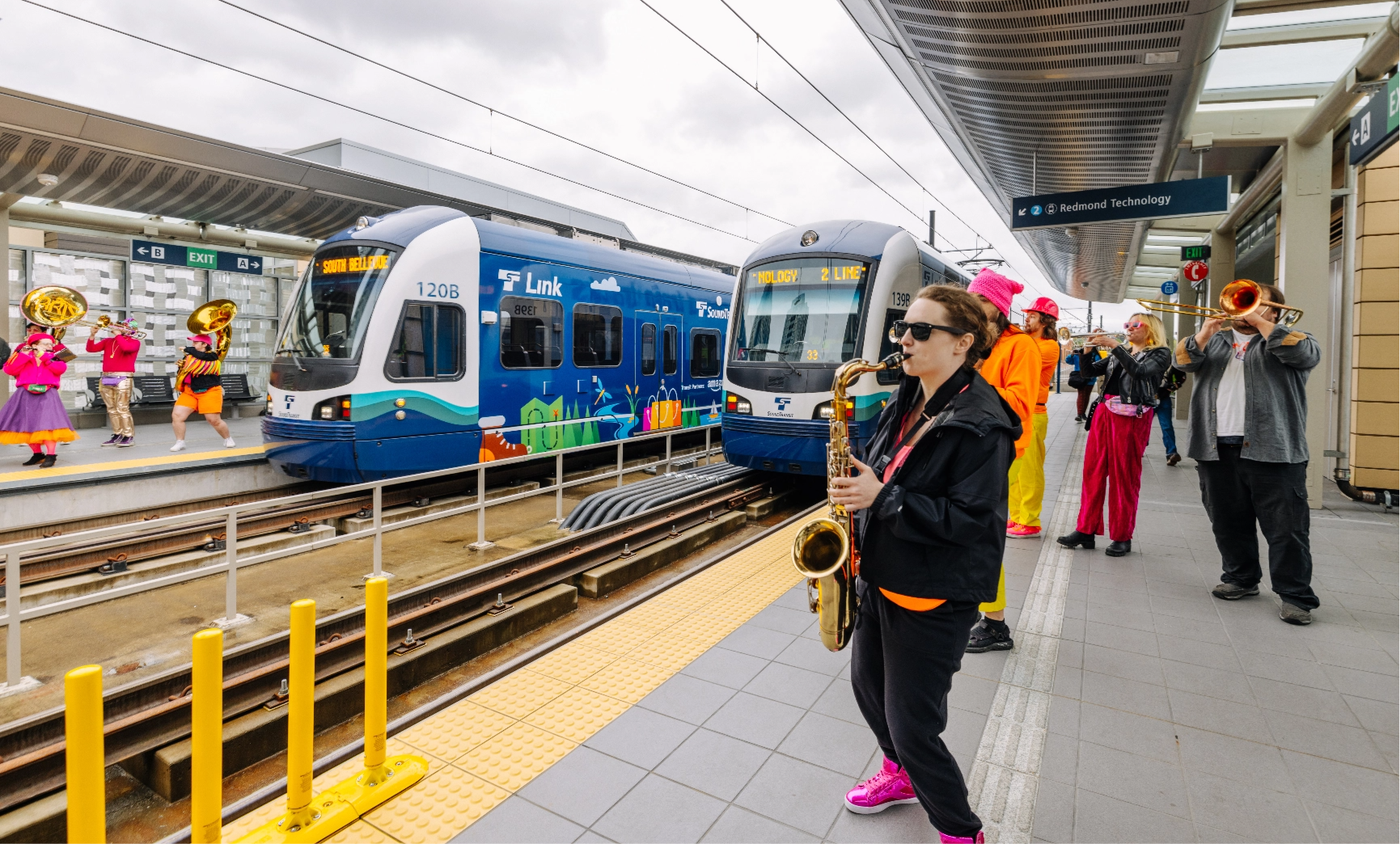 The Neon Brass Party performs on a 2 Line station platform.