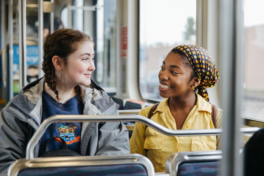 Two young passengers on a Sound Transit light rail train.