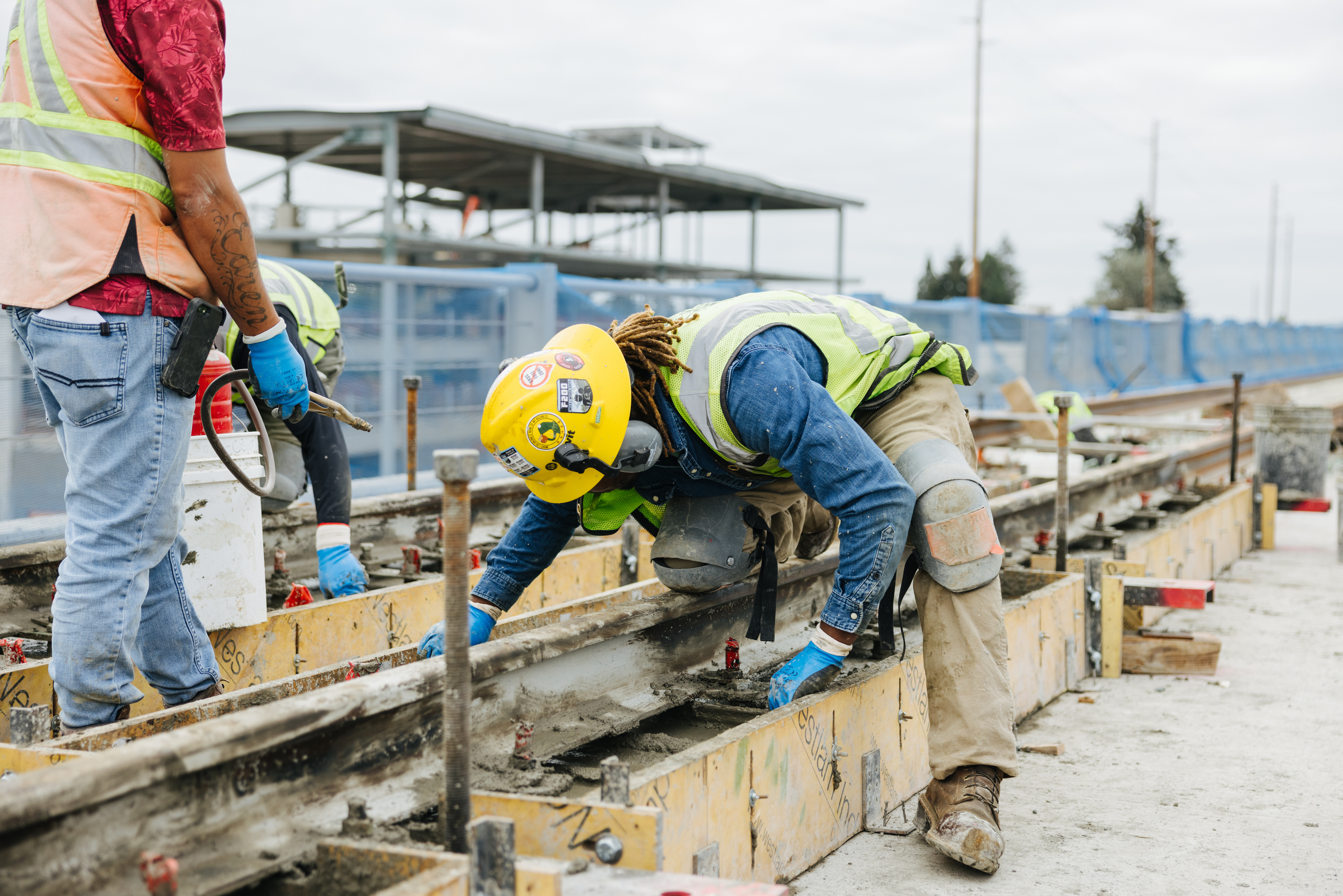 Construction workers doing work on tracks on the Federal Way Link Extension.