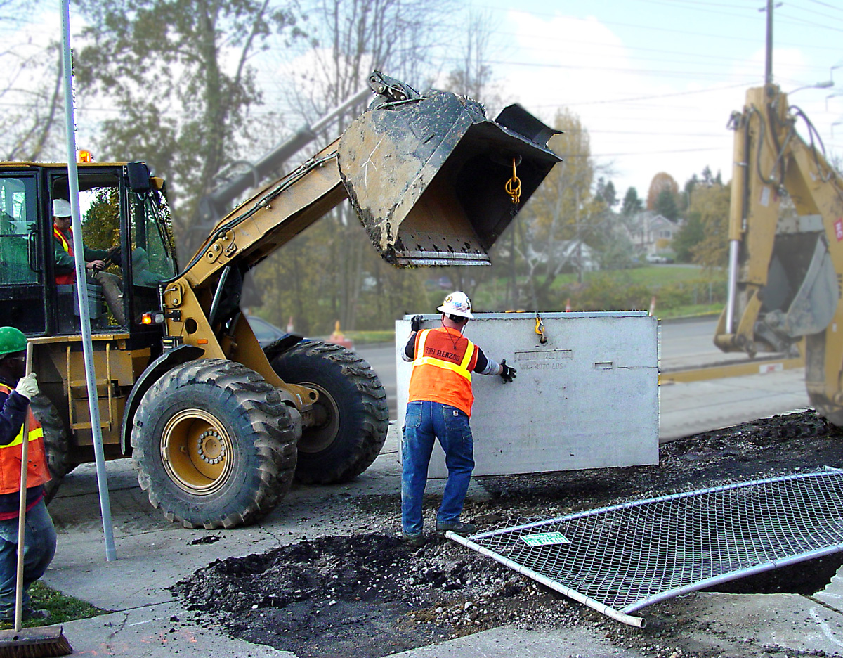 Construction crew works on an utility vault.