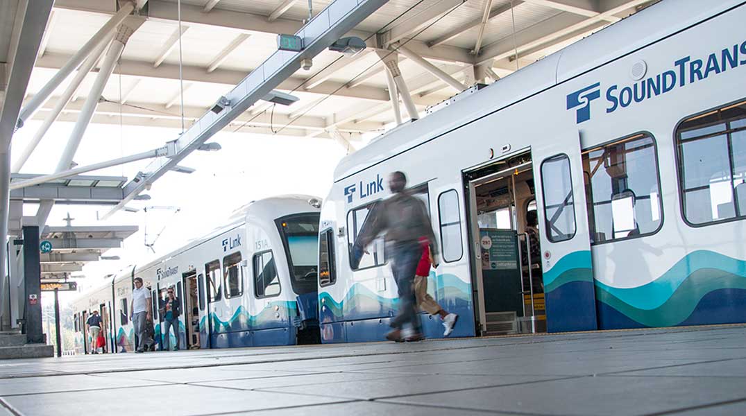 Passenger disembarks the Link light rail train.