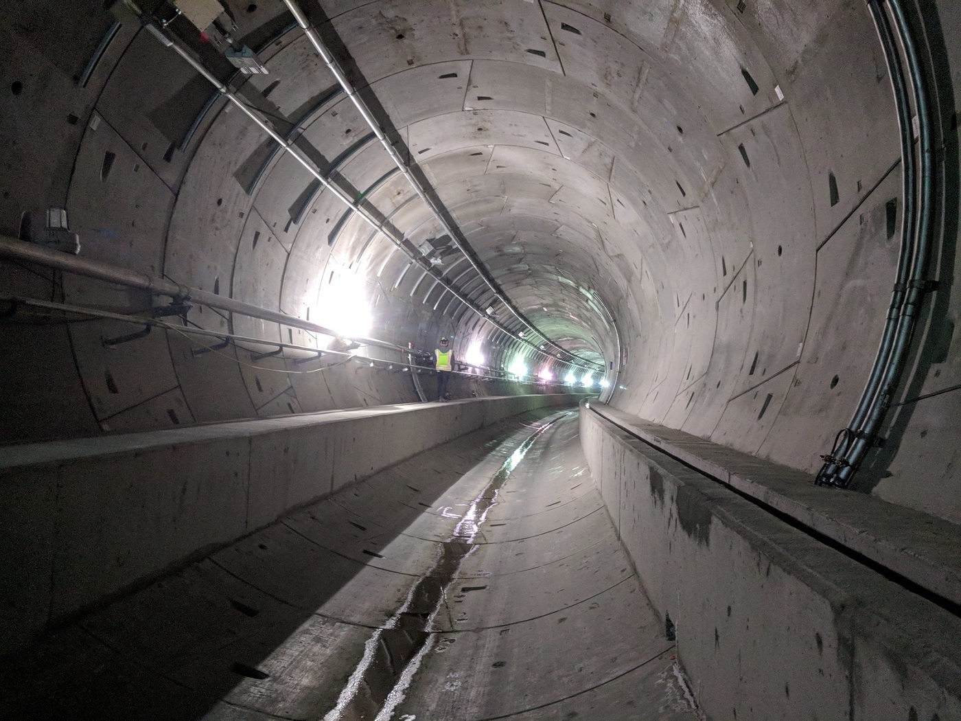 Worker walking in the empty Northgate tunnels prior to rail installation