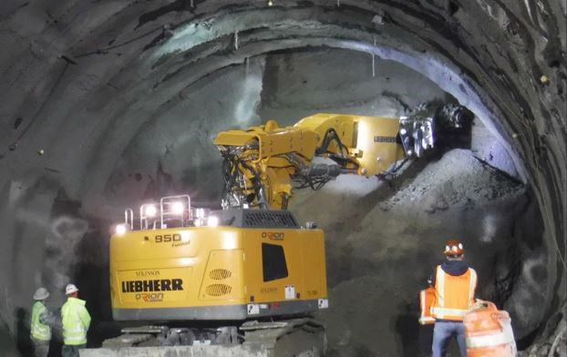 Soil is removed with excavation equipment called a roadheader, which features a rotating cutting head.