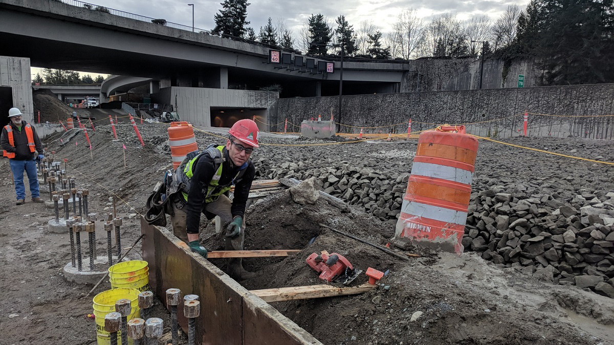 Carpenters build wood forms that will be filled with concrete. Once cured, these will form the foundation for the platform’s sound walls.