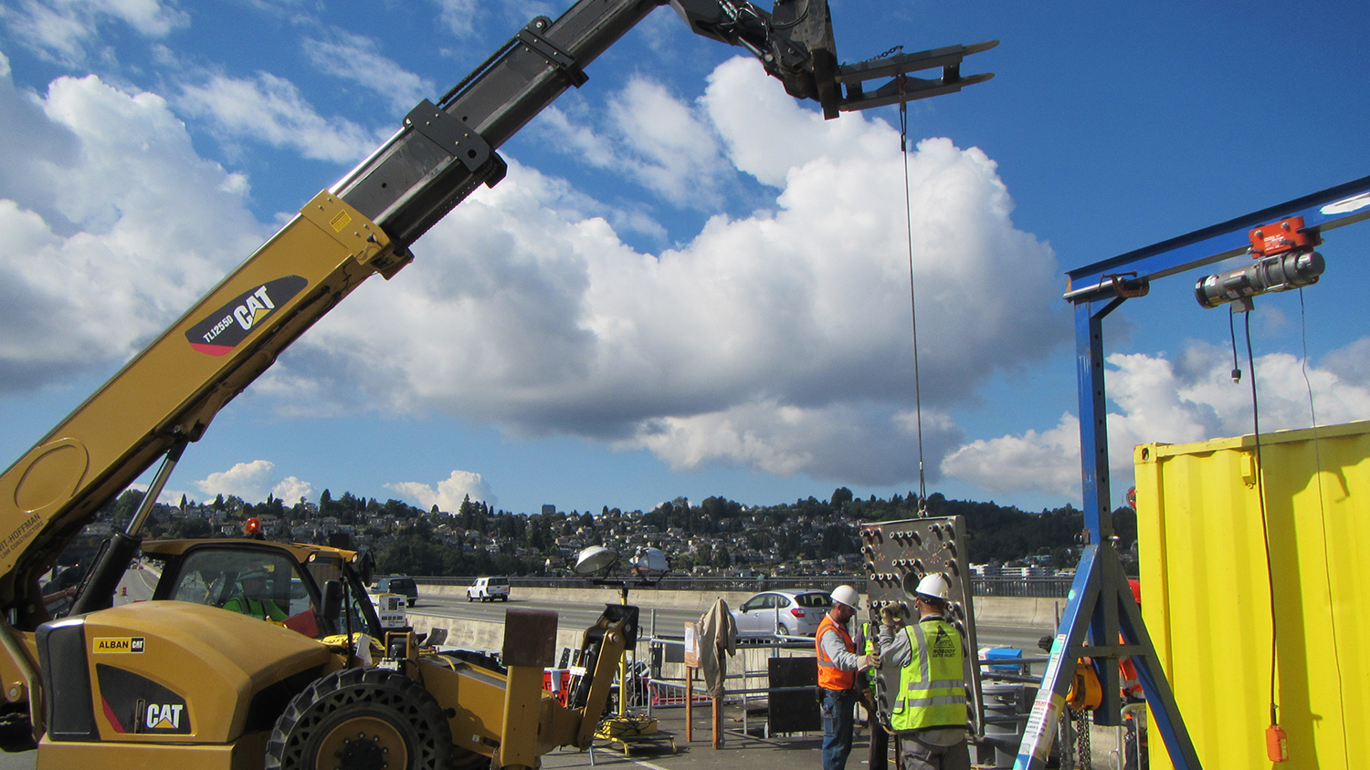 Crews lower steel anchor caps into the floating bridge pontoons. Each anchor cap weighs 3,500 pounds.