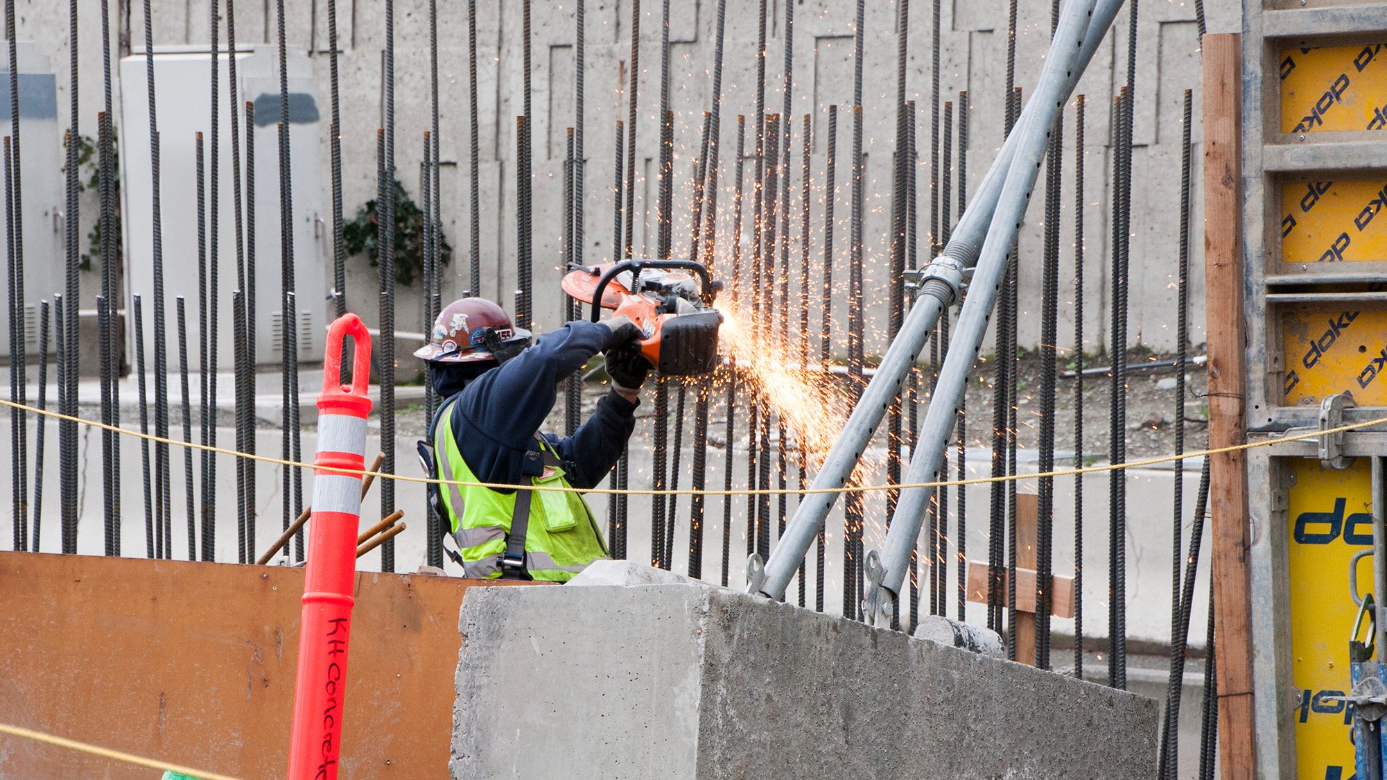 An iron worker cuts rebar for installation of the concrete sound wall at the Mercer Island station.