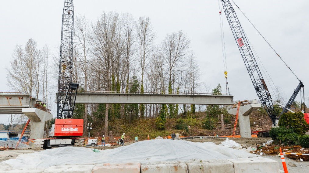 Construction crews will use cranes to place girders between columns.