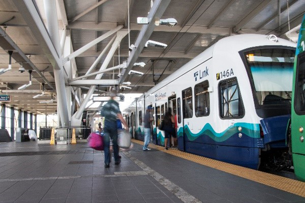 Passengers board a Link light rail train.