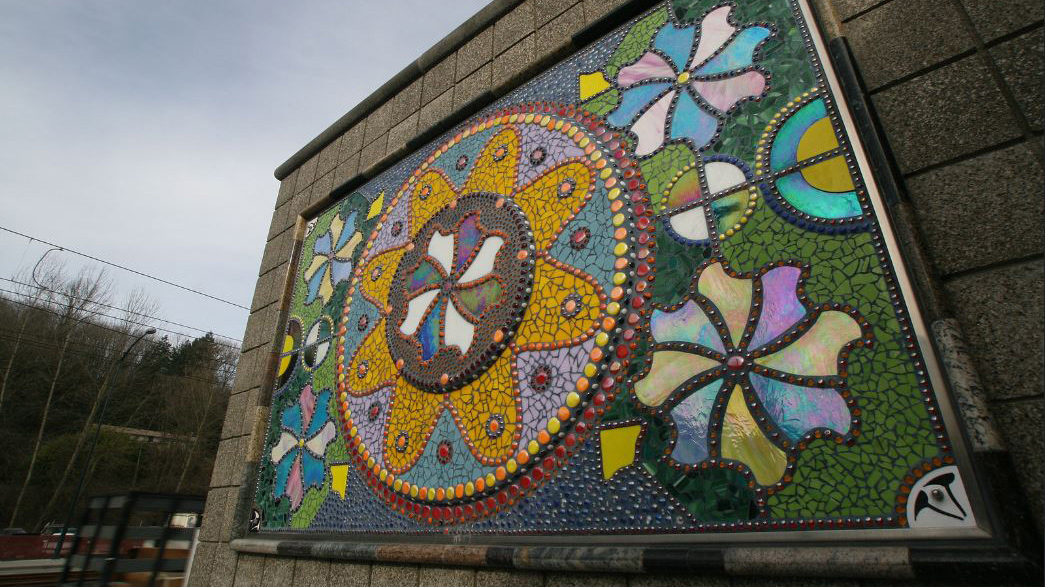 (c) Mauricio Robalino, Flores, Fishmobile Crossing, Pinwheel mosaic and gate, 2009, all rights reserved / Rainier Beach Station, Seattle