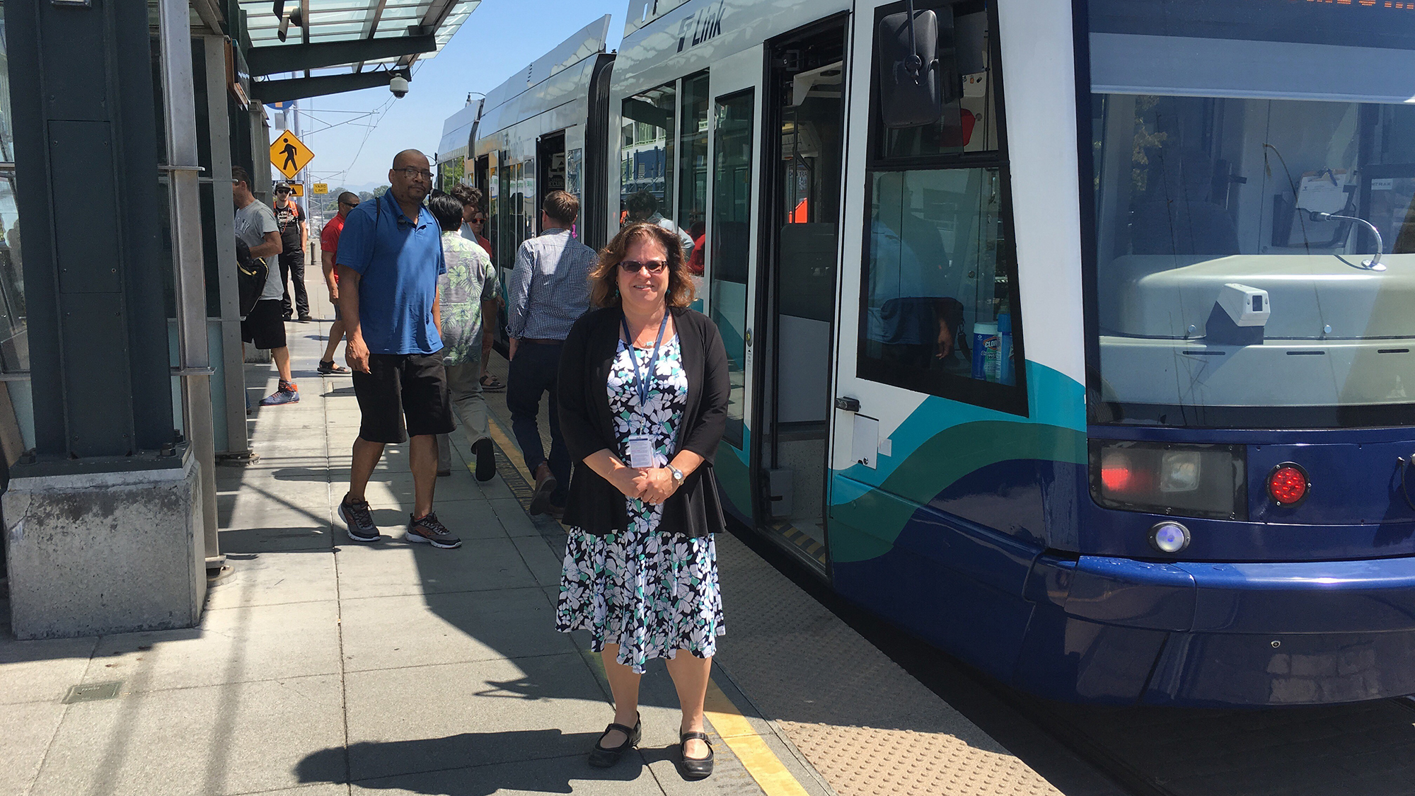 Liz Satterthwaite in front of a Tacoma Link train.