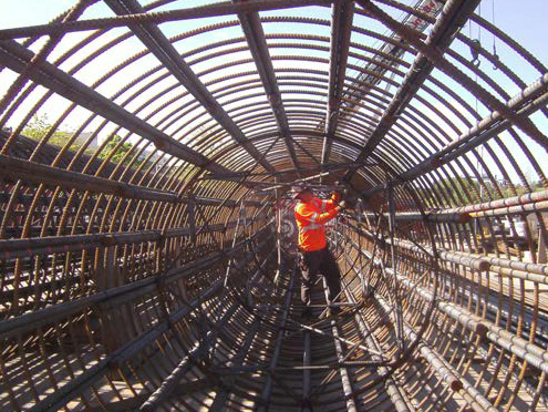 Worker ties rebar cage ahead of column work at Northgate Station site. 