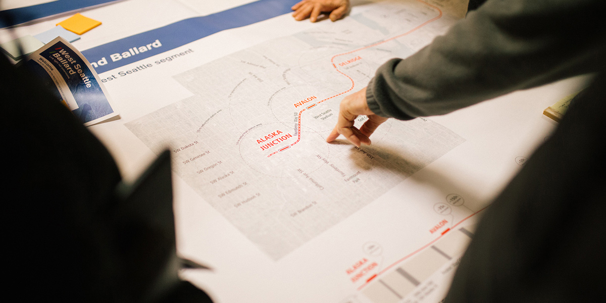 Community members look at the West Seattle segment route map.