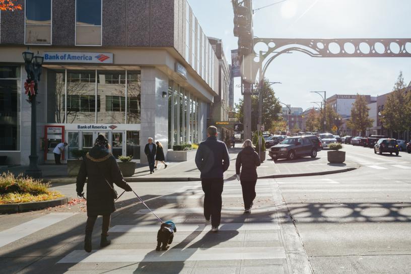 People cross the street toward a Bank of America in downtown Everett.