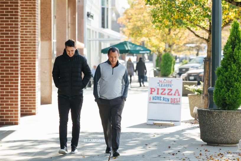Two men walk down the street in downtown Everett.