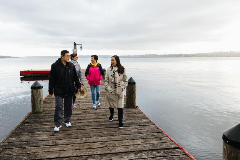 People walk on a pier at Marina Park in Kirkland.