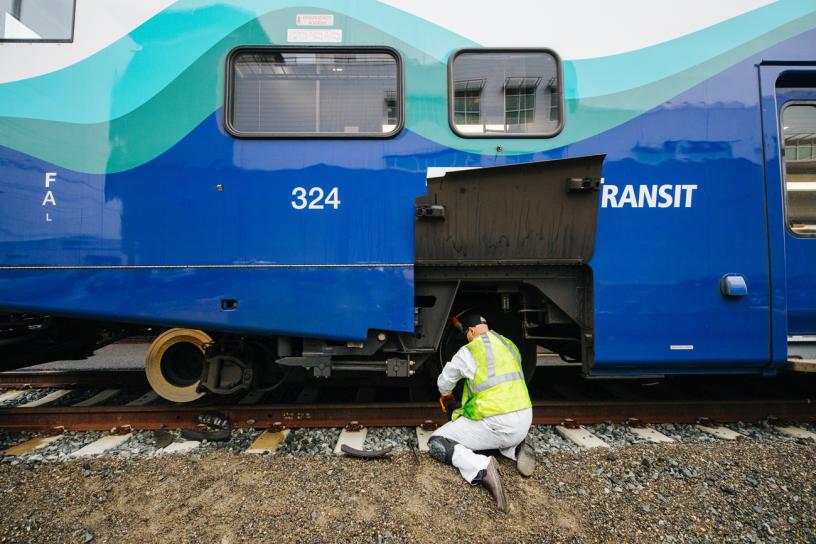A maintenance crew member replaces brake pads on a Sounder car at the Sounder maintenance base in Seattle.