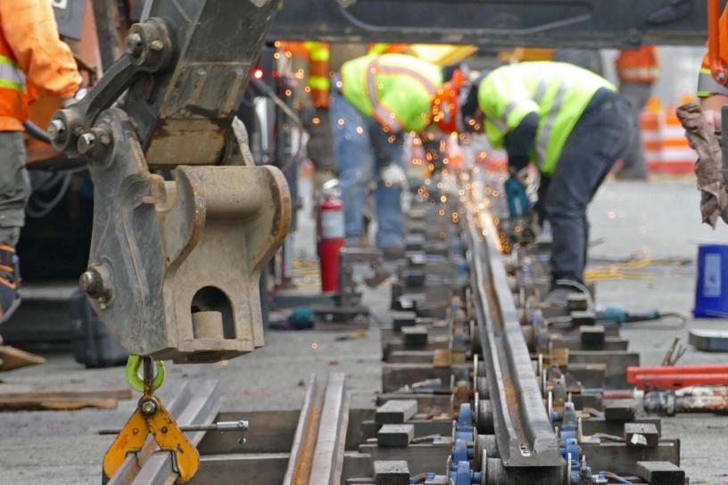 Construction crews weld rail on Martin Luther King Jr. Way in Tacoma.