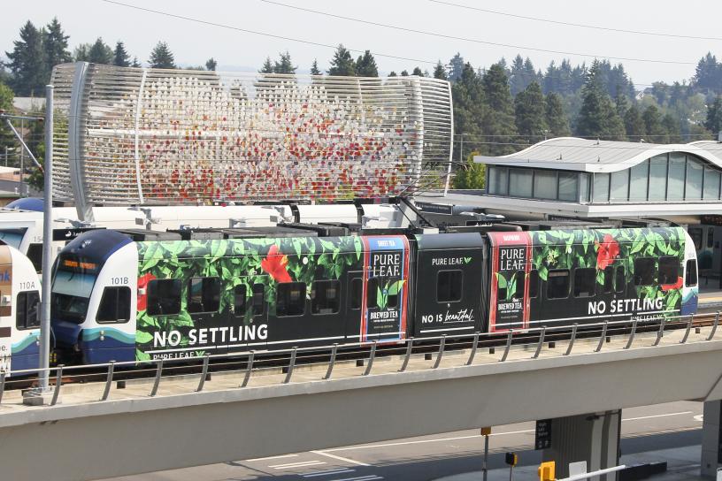 Photo of link light rail car in a graphic train wrap 