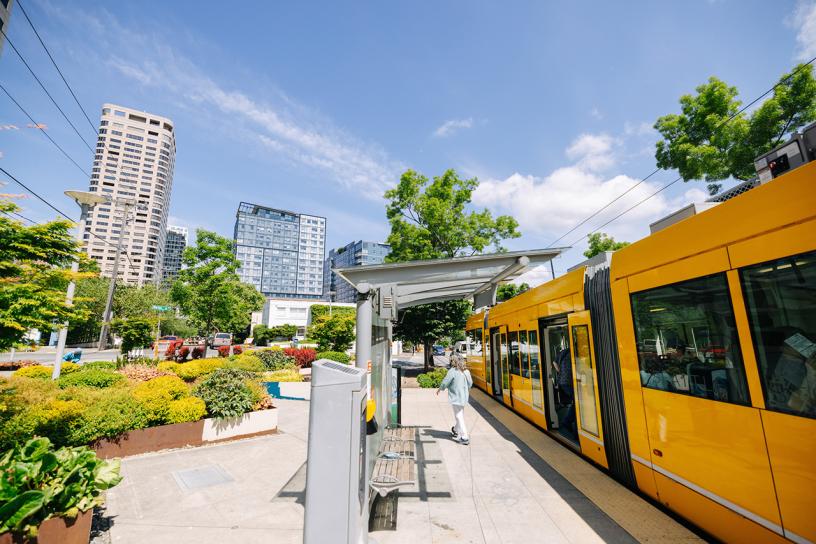 A streetcar stop with a passenger exiting the streetcar.