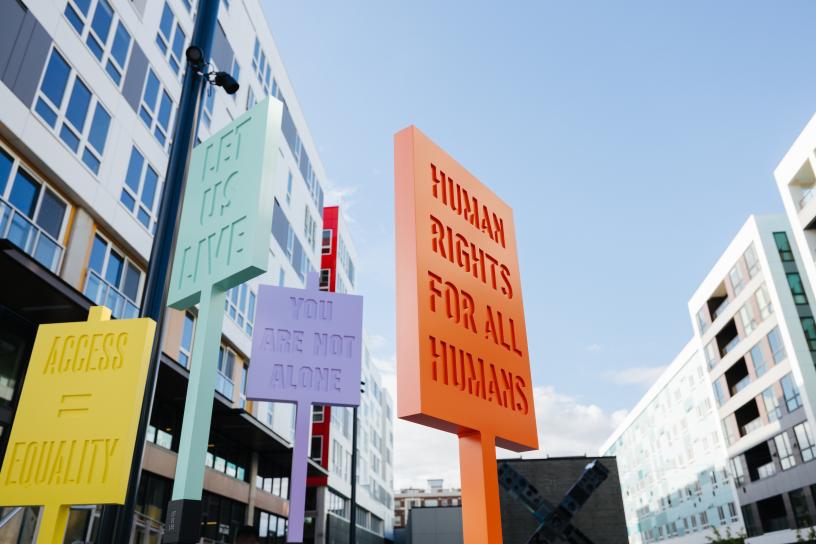 various signs near Capitol Hill Transit-oriented development displaying equality messages