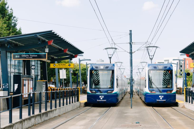 Two 1 Line trains are stopped at Othello Station to board passengers. 