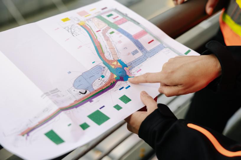 A person looks at plans for the new station in Federal Way