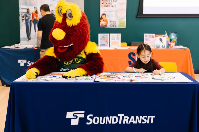 Community members and Seattle Storm mascot "Doppler" during the 2025 Transit Safety Fair.