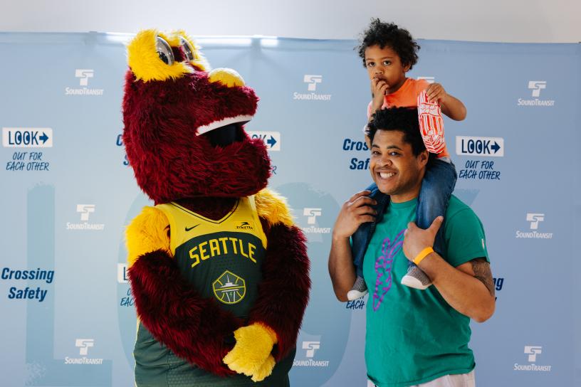 Community members and Seattle Storm mascot "Doppler" at the 2025 Transit Safety Fair.