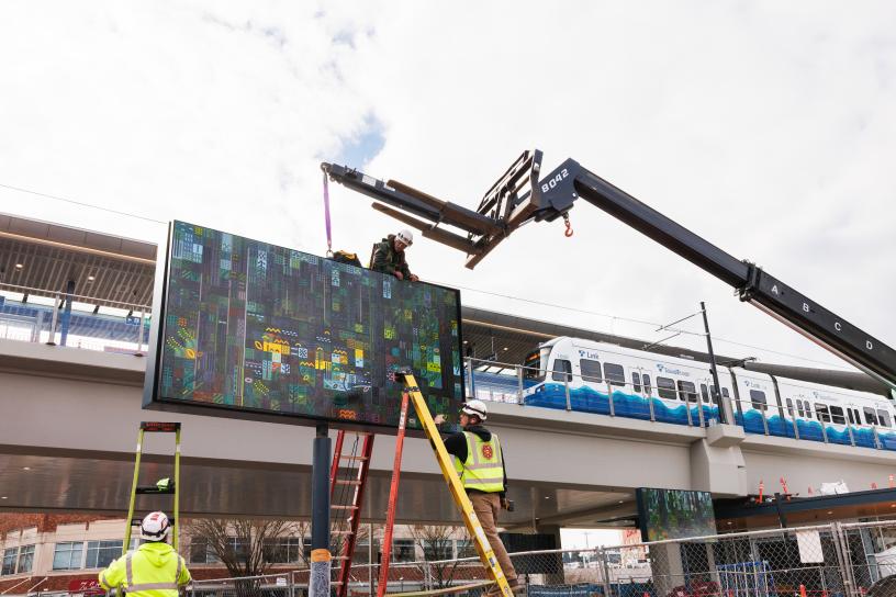 "Bitstreams - 03" is installed at Downtown Redmond Station as a Link train runs in the background.
