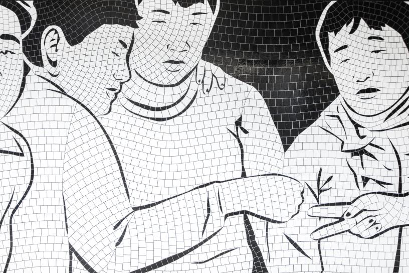 A black and white mosaic shows people playing "Rock, Paper, Scissors."