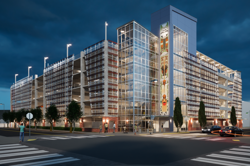 Nighttime digital rendering of the completed Auburn Station parking garage. The structure includes decorative exterior screening, a glass elevator tower with integrated public art, street trees, pedestrian crossings, and enhanced station-area lighting.