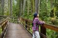 Woman stands on a bridge at the West Hylebos Wetlands Park.