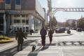 People cross the street toward a Bank of America in downtown Everett.