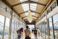 Commuters walk across the Mukilteo Sounder Station bridge.